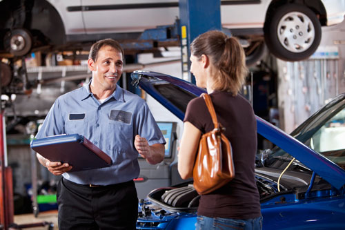 Mechanic helping a satisfied customer